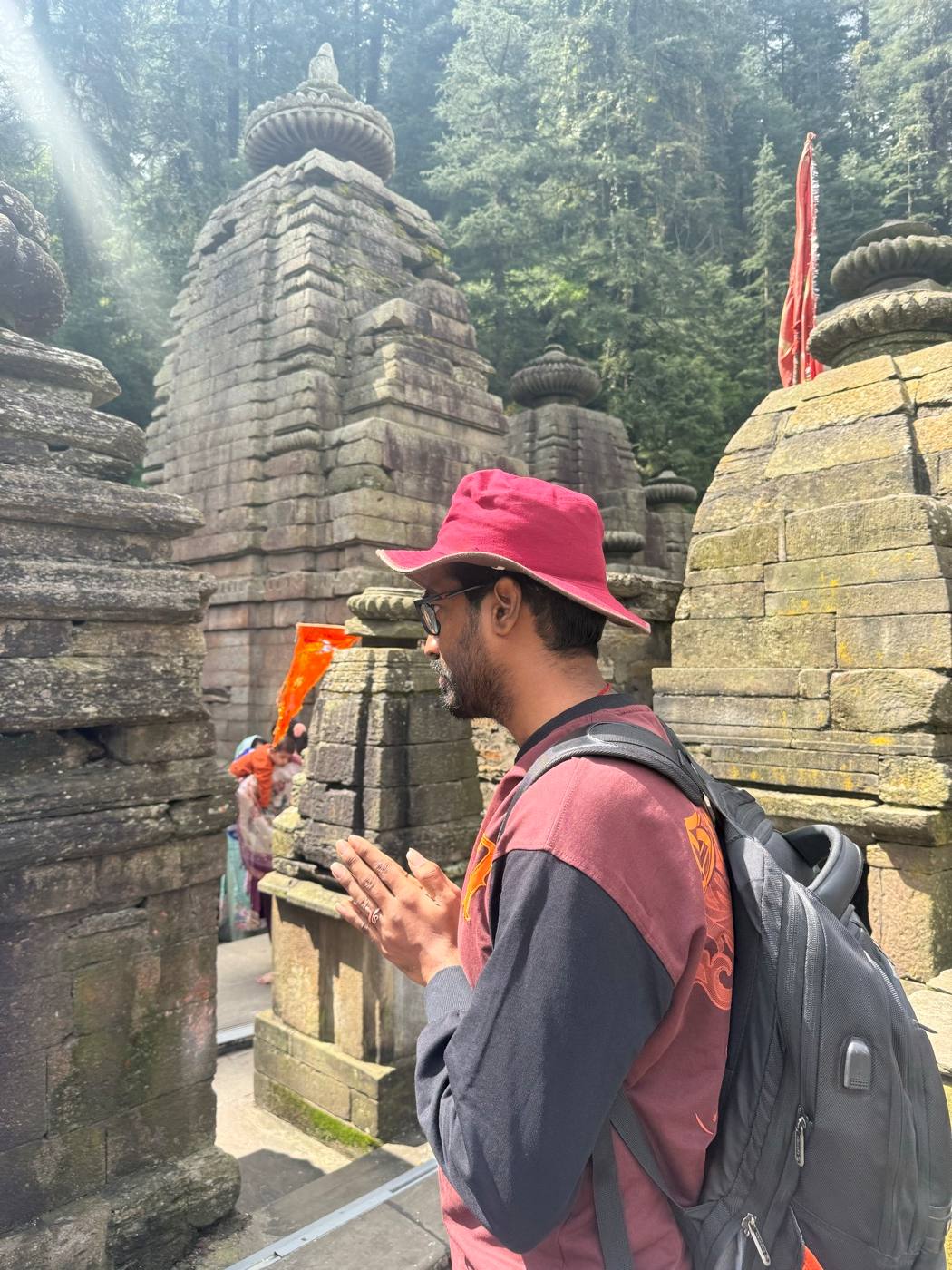 Offering prayers among the stone temples of Jageshwar Dham.