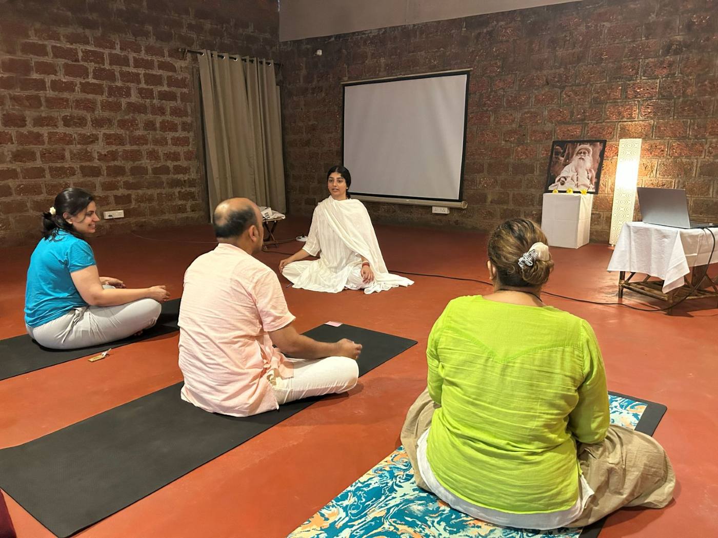 Participants meditating together in the practice hall, Goa retreat.