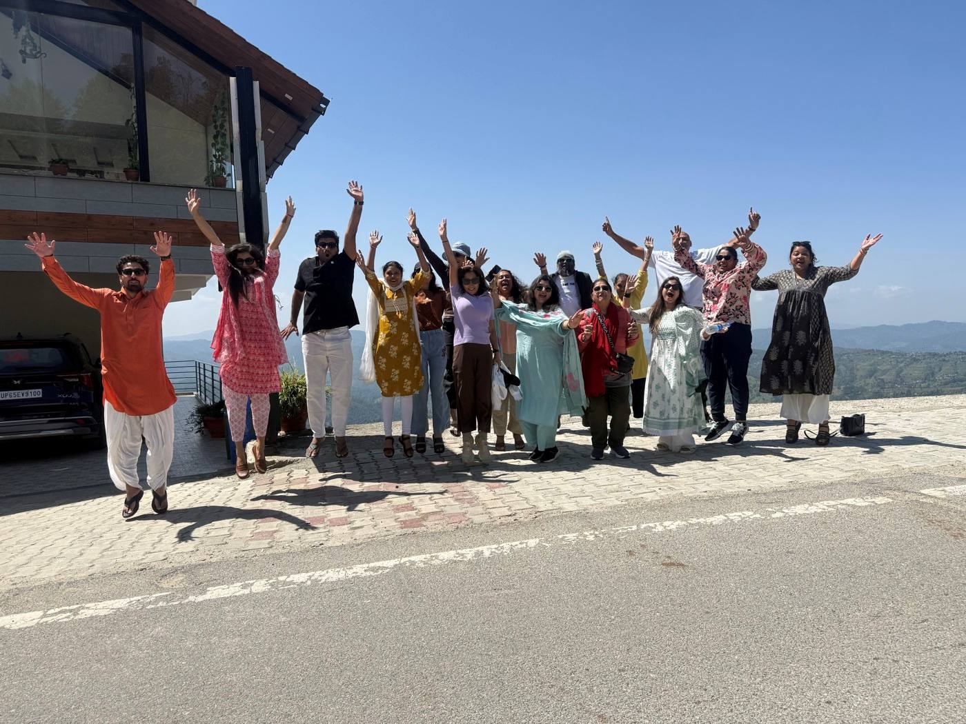The Kasar Devi group celebrating together on a mountain road.