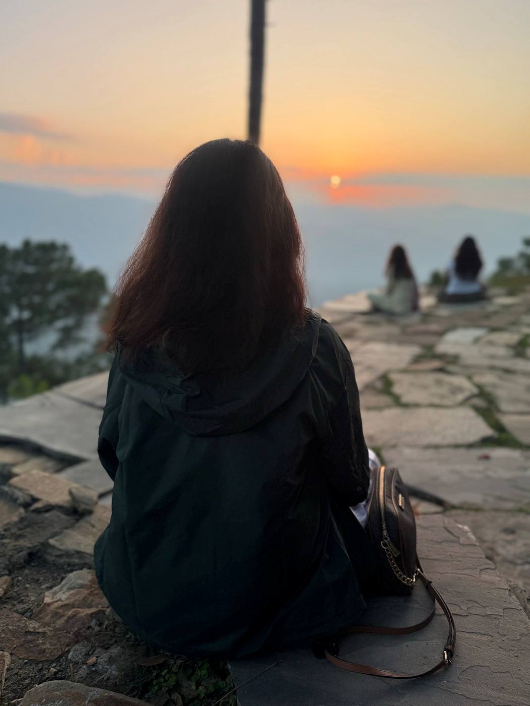 A seeker sitting before the sunset at Kasar Devi.