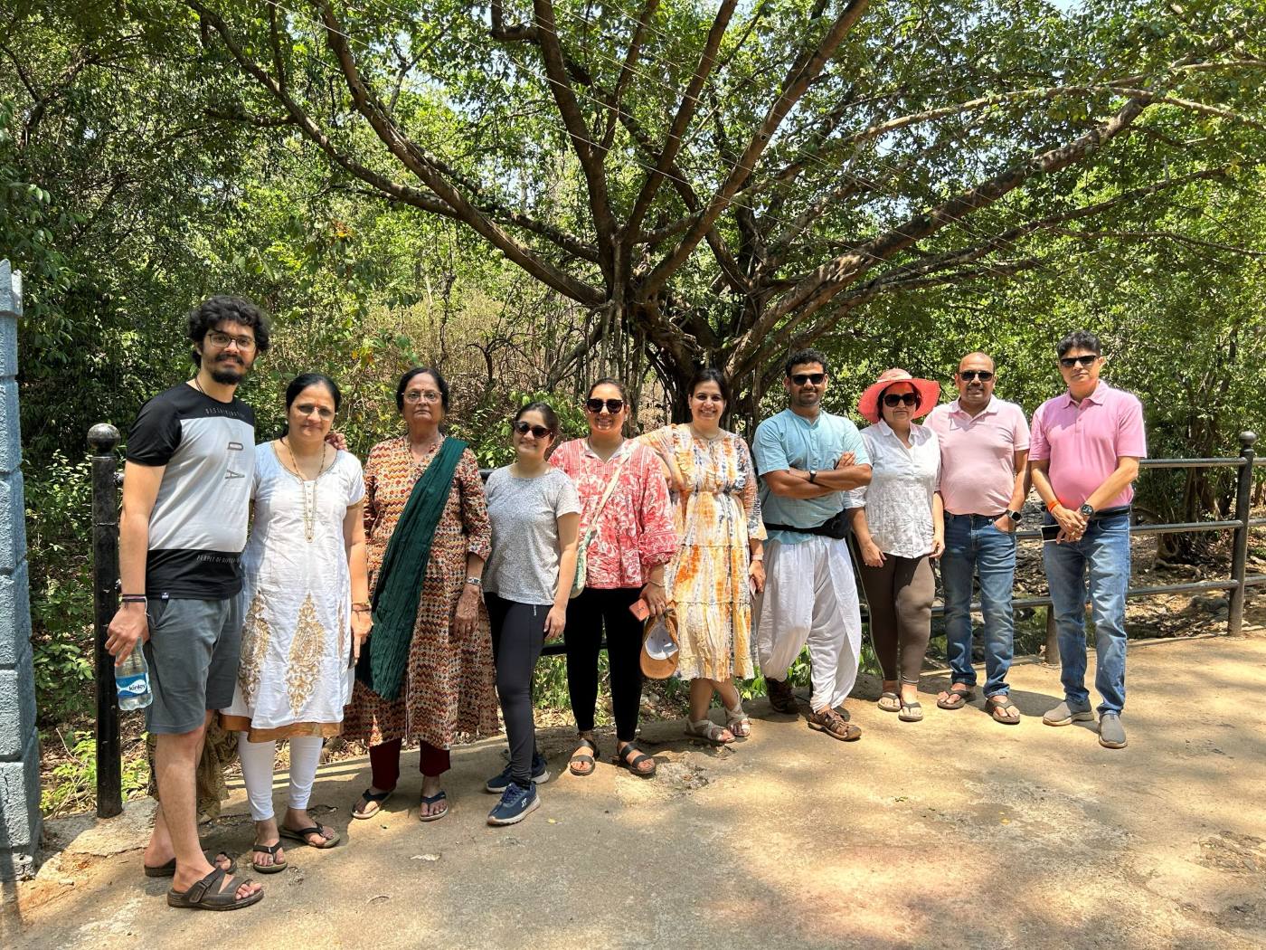 Retreat participants standing together under a large banyan tree in Goa.