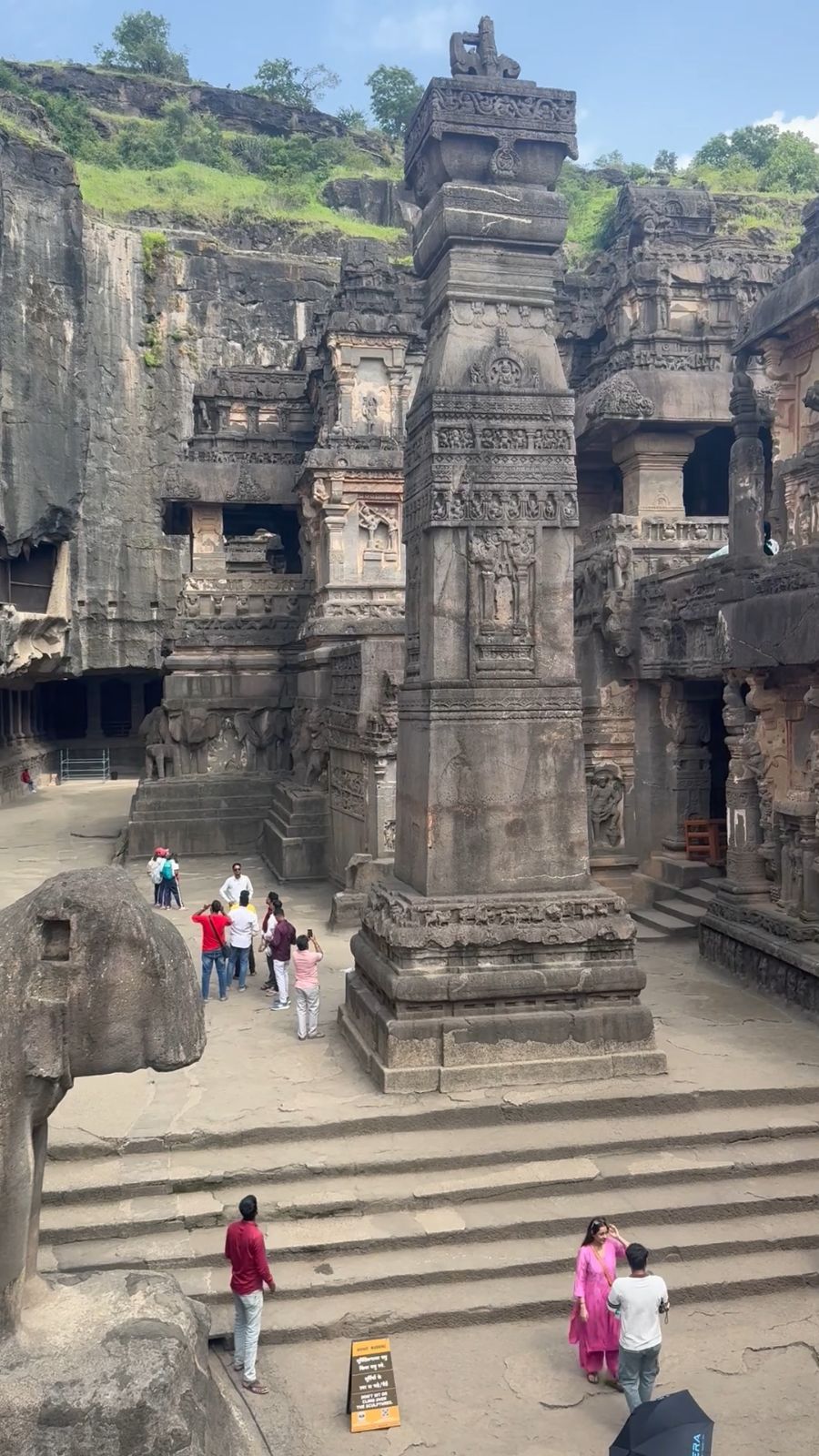 The stone elephant and victory pillar in the courtyard of Kailasa Temple.